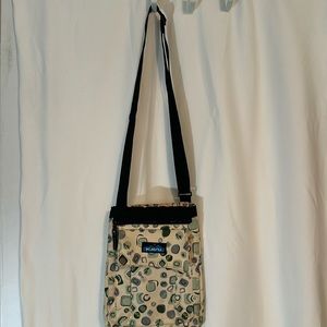 KAVU cross bodied purse. Made of canvas. 2 extra pockets on front. One in back.